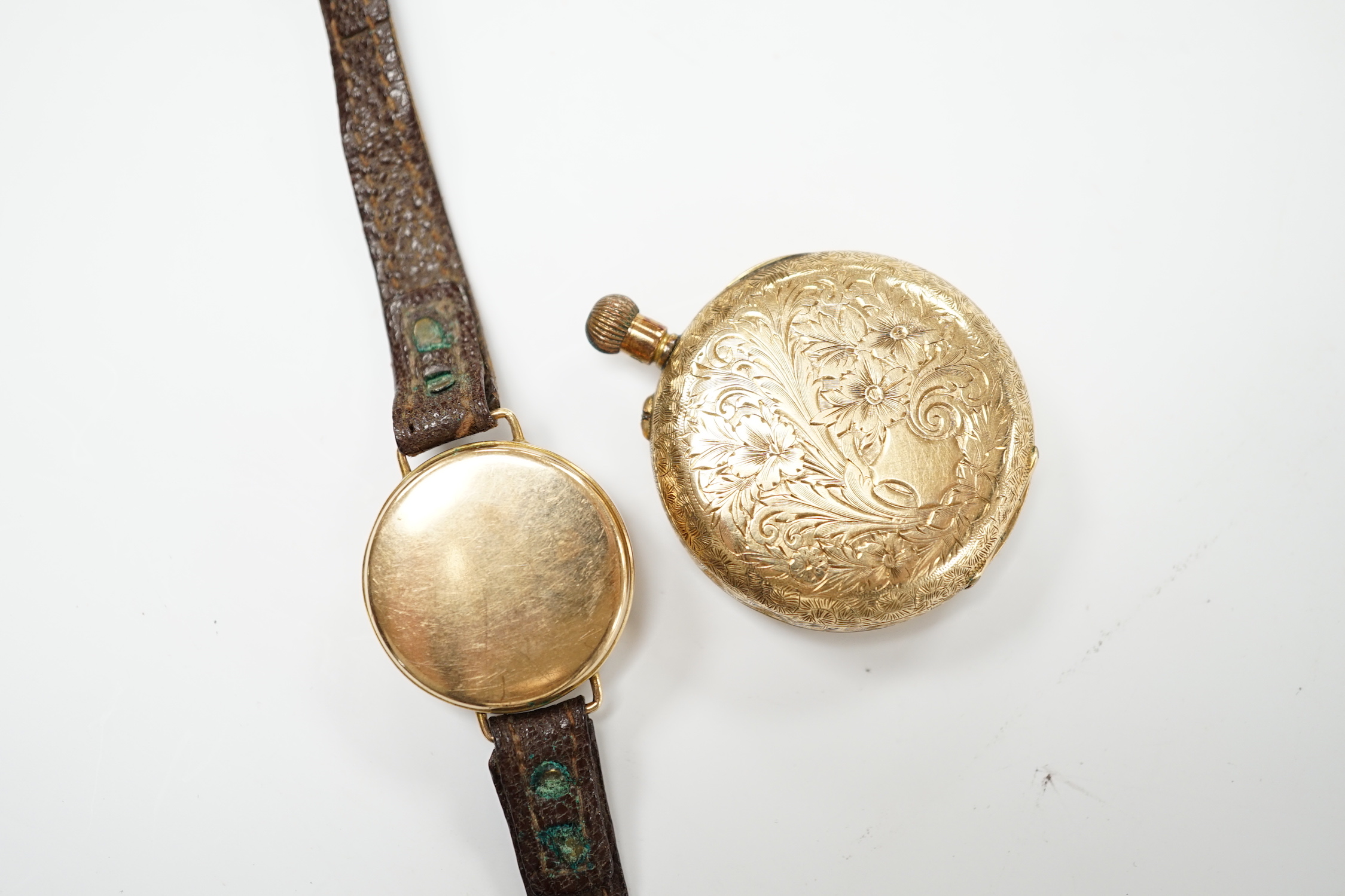 A 14k open faced keyless fob watch, with Roman dial, gross weight 31.7 grams and a lady's 9ct gold manual wind wrist watch (lacking winding crown), on a leather strap.